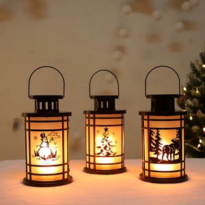 Three decorative Christmas lanterns with snowman and elk patterns emitting warm light
