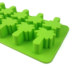Close-up of green silicone mold with multiple coconut tree shapes for ice cubes