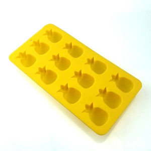 Detail view of a yellow silicone mold with 12 cavities in a pineapple shape for baking