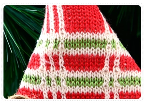 Macro detail of red and white striped knit texture on Christmas plush decoration