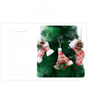 Detail of red and green plaid Christmas ornaments with pine cones on a Xmas tree