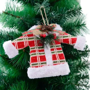 Plaid knitted Christmas sweater ornament with mini pine cones hanging on a tree