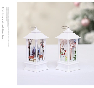 Detail of white Christmas lanterns with reindeer and snowman patterns in a cozy setting