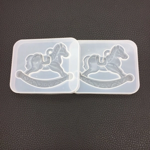 Detailed view of two rocking horse silicone molds for resin casting and DIY ornaments