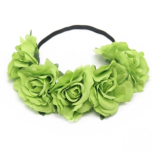 Detailed macro view of green fabric rose flowers and leaves on a black headband