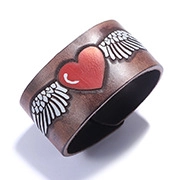 Macro shot of vintage bronze wide ring featuring a red heart and white angel wings
