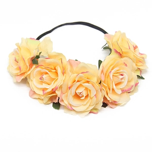 Detail of yellow and pink faux rose flower crown on a black elastic headband for parties