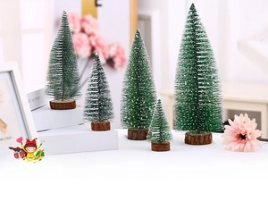 Detailed view of 5 mini frosted Christmas trees with snow effect and solid wood bases