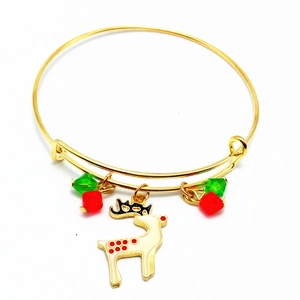 Detail of Christmas bangle featuring a golden reindeer charm with red and green beads