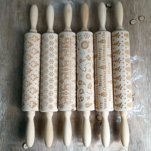 Detailed set of six wooden Christmas rolling pins with festive elk and snowflake engravings