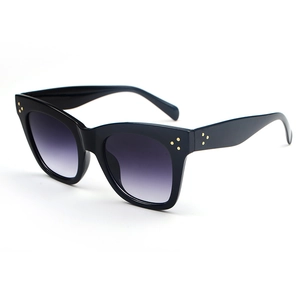 Oversized cat-eye sunglasses in black with purple gradient lenses and gold studs