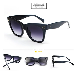 Detail view of oversized black square sunglasses with gradient lenses and triple gold studs