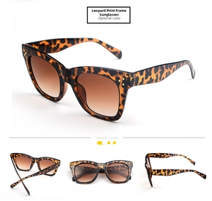 Close-up of leopard print oversized sunglasses with gradient lenses and gold rivets