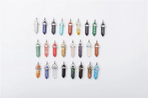 Detailed overhead view of 24 assorted hexagonal quartz crystal bullet point pendants