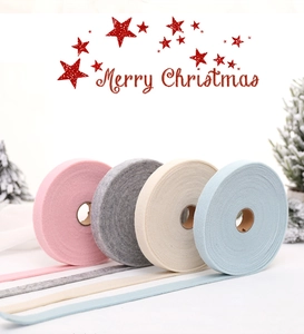 Macro shot of macaron felt wool ribbons on paper spools for Christmas DIY decor