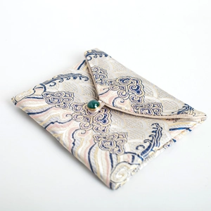 Traditional Chinese silk brocade jewelry gift pouch with cloud pattern and green gem closure