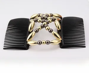 Detail of magic hair comb with gold and grey beads on black double-row plastic teeth