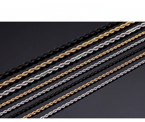 Detailed view of twisted rope chains in black, gold, and silver finishes with a sleek texture