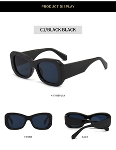 Detail view of bold black wide temples and irregular square frame of trendy sunglasses