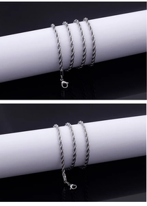 Macro detail of silver stainless steel twisted rope chain with secure lobster clasp