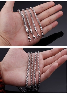 Macro detail of silver stainless steel twisted rope chains with lobster clasp closures