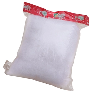 Artificial white snow cotton filler in packaging for Christmas holiday scene decorations