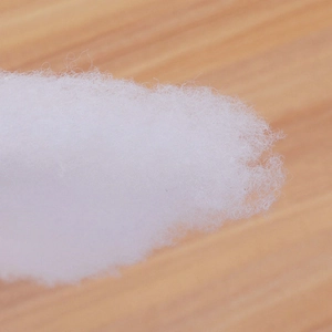 Artificial white snow cotton fiber for Christmas decoration on a wooden surface