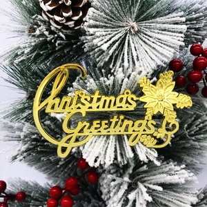 Golden Christmas Greetings sign with snowflakes on snowy pine branches and berries