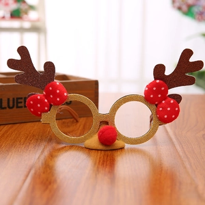 Close-up of festive Christmas reindeer antler glasses with brown glitter and red bow