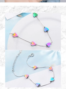 Detail view of colorful heart charms on silver bracelet with adjustable extension chain