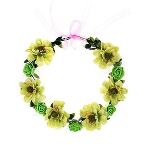 Close-up of artificial floral wreath with green roses, leaves and pink ribbon bow detail