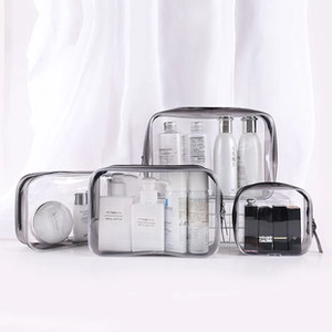 Set of four transparent grey PVC travel bags in various sizes for cosmetics and toiletries