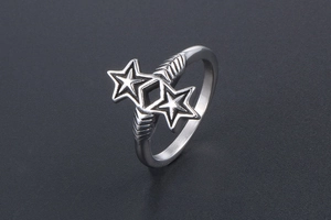 Macro shot of silver retro star ring featuring twin stars and diamond metal texture