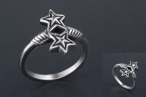 Macro view of silver star ring with textured band and diamond pattern details