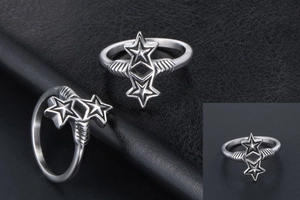 Macro shot of silver ring with double stars and wing textures on dark leather