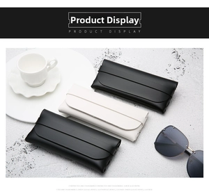 Detail of leather sunglasses cases with premium stitching in black and off-white colors