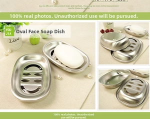 Detail of oval stainless steel soap dish featuring a smiley face drainage design
