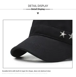 Detail view of black canvas flat top cap with silver star rivet and shaped brim
