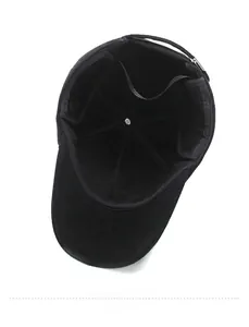 Detail view of black corduroy baseball cap interior with reinforced seams and metal buckle
