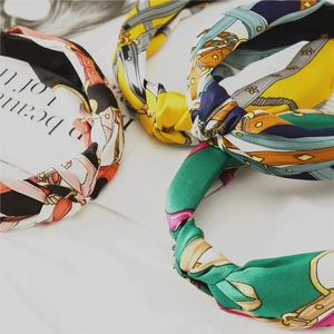 Detailed display of satin knotted headbands featuring vintage horse bit and chain patterns