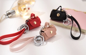 Mini PU leather coin purses in red, pink, and black with metal clips and long wrist straps