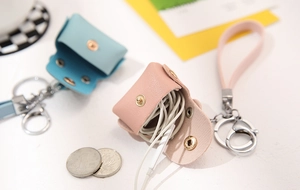 Detail of pink and blue PU leather mini coin pouches with snap buttons and keyrings