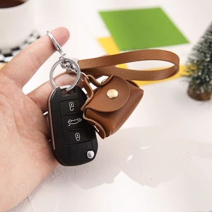 Mini brown leather coin purse with wrist strap and gold buckle for keys and storage
