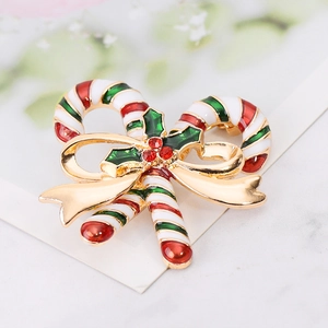 Detail of Christmas candy cane brooch with gold plating, colorful enamel and red rhinestones