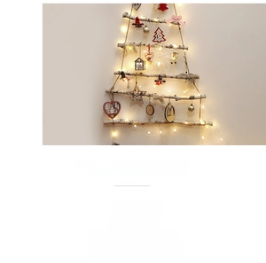 Detail of wooden Christmas tree wall hanging with warm LED lights and rustic ornaments