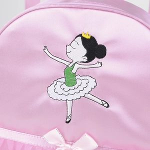 Close-up of pink satin ballet bag with embroidered girl in tutu and pink bow