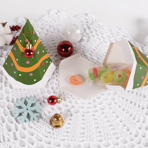 Green Christmas tree shaped gift box with festive red ornaments and polka dot pattern