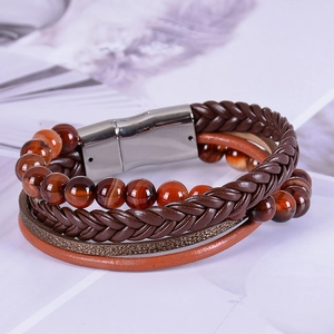 Macro detail of multi-layer leather bracelet with natural tiger eye beads and magnetic clasp
