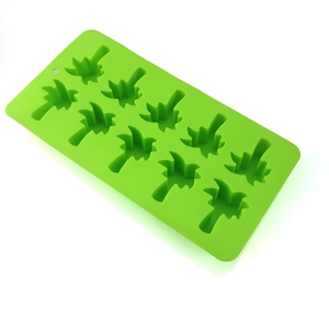 Macro detail of green silicone mold with coconut tree shaped cavities for chocolate