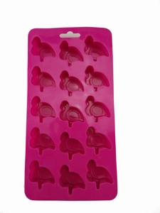 Detail of pink silicone mold with 15 flamingo shaped cavities for chocolate and cake making